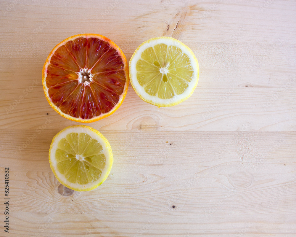 sicilian red oranges and yellow lemons on the wooden background, top view. Healthy lifestyle, vitamin C and Mediterranean diet sicilian red oranges and yellow lemons on the wooden background, top view. Healthy lifestyle, vitamin C and Mediterranean diet