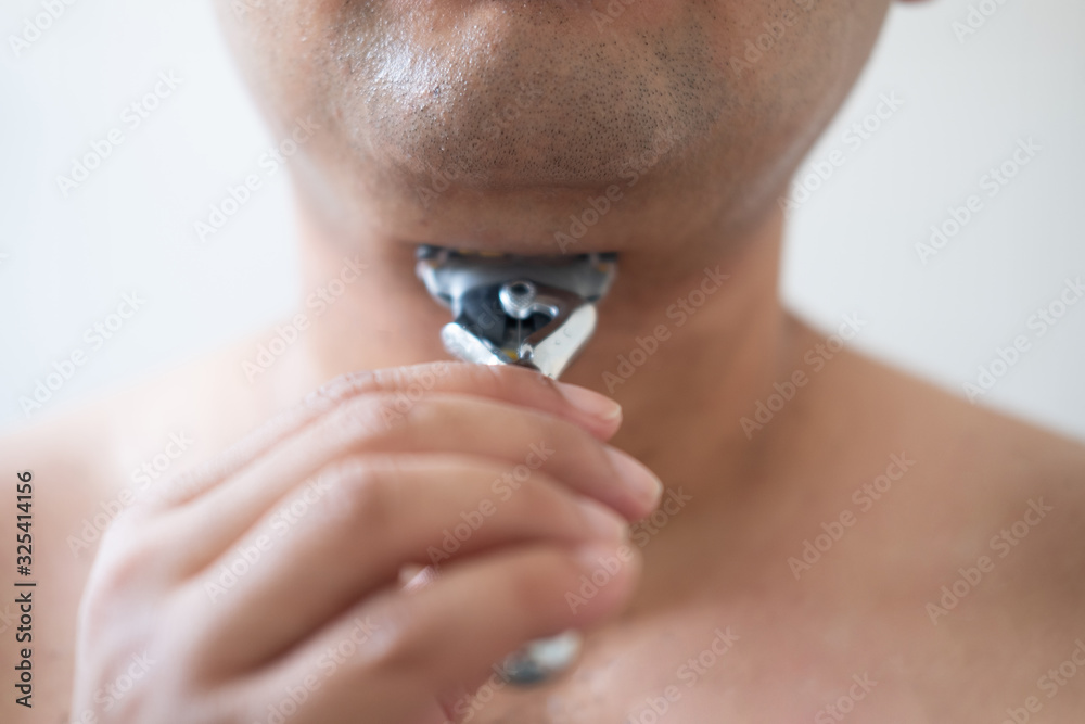 Fototapeta premium Man shaves a shaving machine without using foam