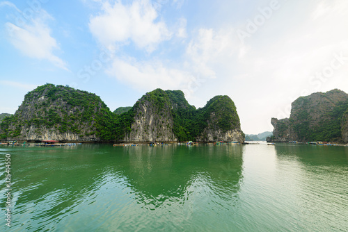 Ha Long Bay, unique limestone rock islands and karst formation peaks in the sea, famous tourism destination in Vietnam. Clear blue sky.