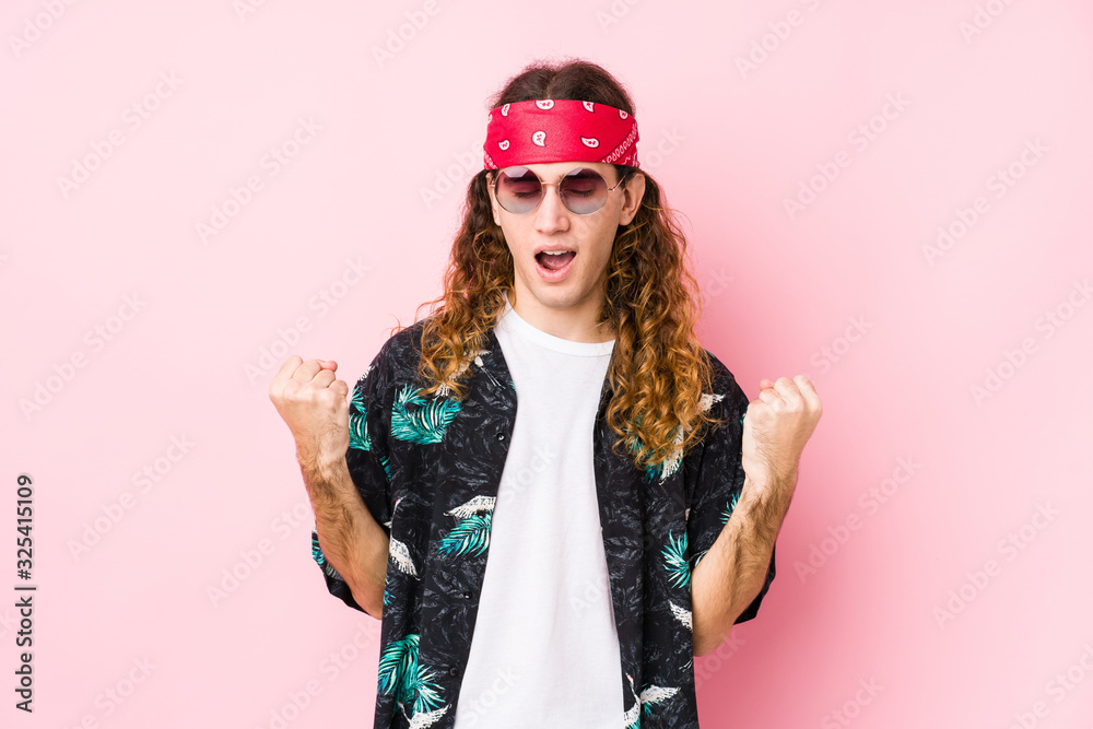 Young hippie caucasian man isolated cheering carefree and excited. Victory concept.