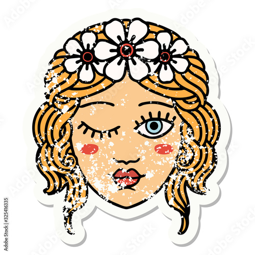 traditional distressed sticker tattoo of a maidens face winking