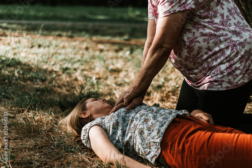 Fainted woman receiving cpr photo