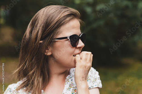Woman nibbling her fingernails