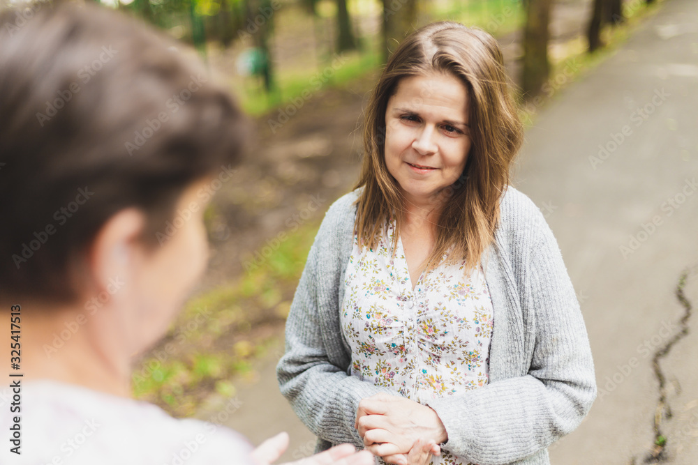 Young woman offering assistance to an elder Young woman offering assistance to an elder