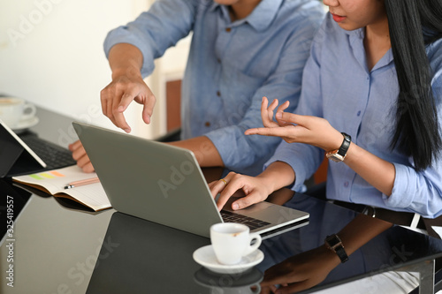 A business development team discussing about their business at the modern working desk.