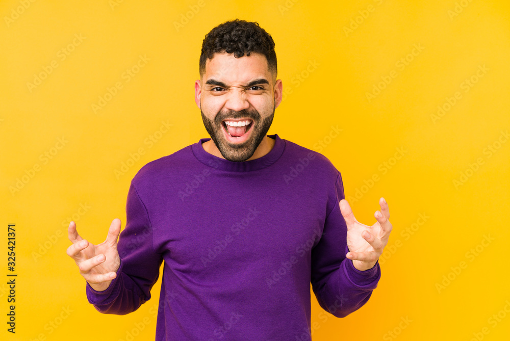 Young mixed race arabic man isolated screaming with rage. Young mixed race arabic man isolated screaming with rage.