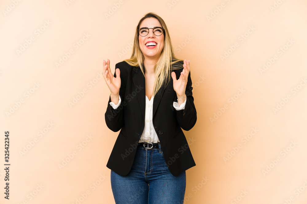 Middle age business woman isolated on beige background joyful laughing a lot. Happiness concept. Middle age business woman isolated on beige background joyful laughing a lot. Happiness concept.