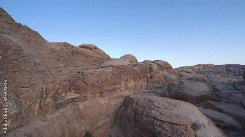 Pan right rocky formation in desert landscape Pan right rocky formation in desert landscape