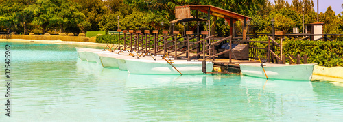 A beautiful place in a city park with water and moored white boats, a perfect place for a romantic time for couples and honeymooners