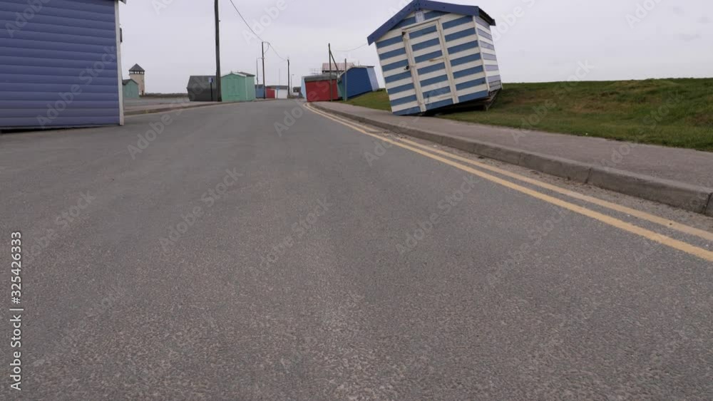 Beach huts that have been moved and dumped on to the road. Damage caused by storm surge created by storm Ciara. Tilt shot. Beach huts that have been moved and dumped on to the road. Damage caused by storm surge created by storm Ciara. Tilt shot.