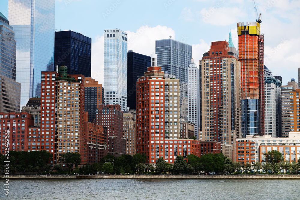 Fototapeta premium Manhattan downtown view with big skyscrapers, New York City, USA. Manhattan beautiful skyline panorama, NYC. Top of the buildings in financial district. Business background.