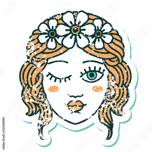 distressed sticker tattoo style icon of a maidens face winking