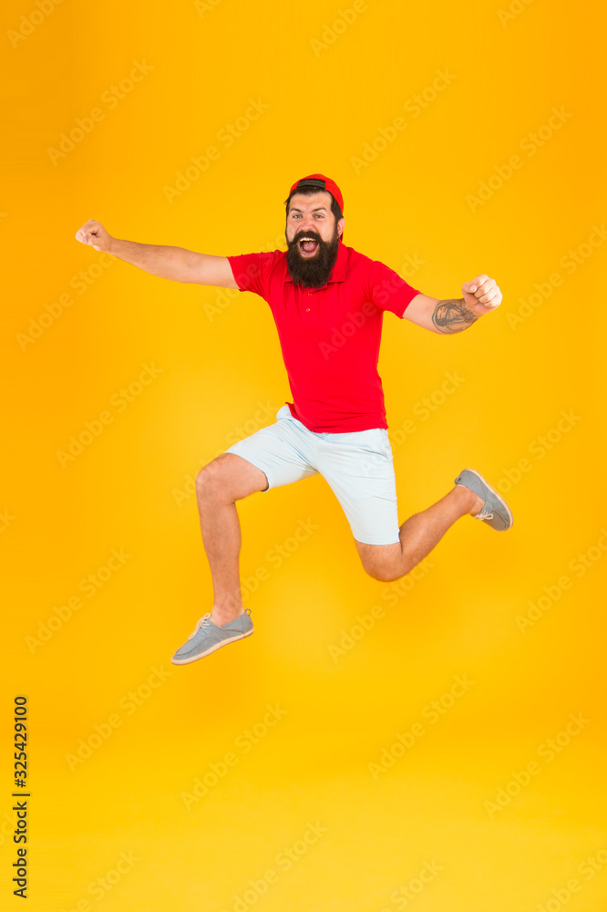 Towards fun. Enjoying active lifestyle. Happy guy jumping. Active bearded man in motion yellow background. Active and energetic hipster. Energy charge. Healthy guy feeling good. Inspired concept