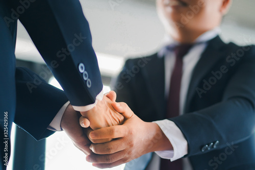 Two businessman shaking hand to congratulate after agreement and deal their business to expand business investment network and building project development, business and agreement concept