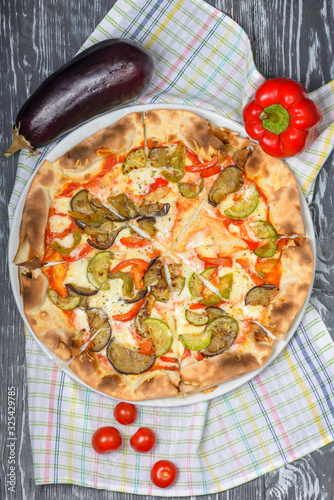 pizza with eggplant, zucchini, sweet pepper, mozzarella cheese and tomato sauce