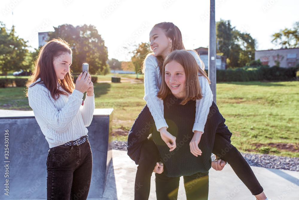 custom made wallpaper toronto digital3 Young girls, schoolgirls, teenagers, pictures record videos smartphone. Casual wear sweater. Emotions happiness, fun, joy, smile, laugh, rest break in college. Best girlfriends, rest after school