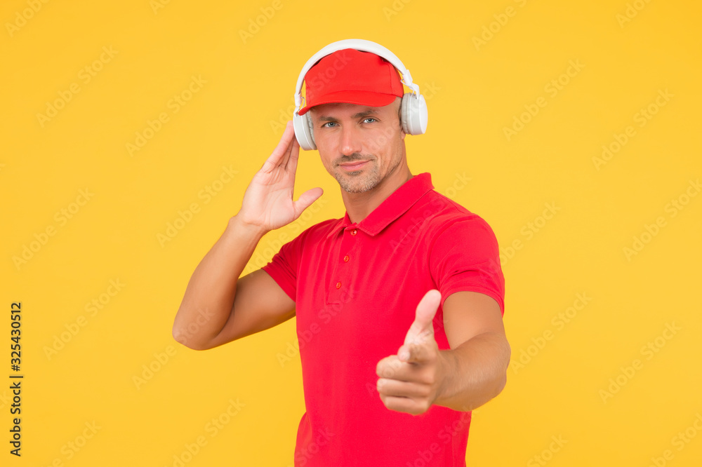 How about you. Guy point finger yellow background. Handsome man listen to music. Stereo sound technology. Technology and music. Modern life. New technology