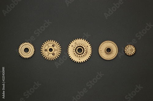 template of five golden gears on gray background