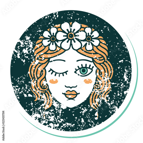 distressed sticker tattoo style icon of a maidens face winking