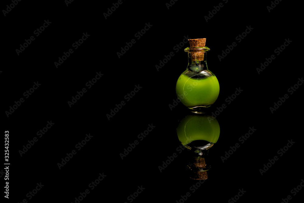 Glass test tubes with green liquid isolated on black background. Glass test tubes with green liquid isolated on black background.