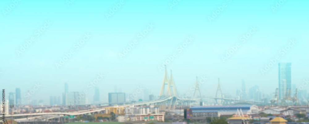 Blur photo of city scape include towers and toll way bridge