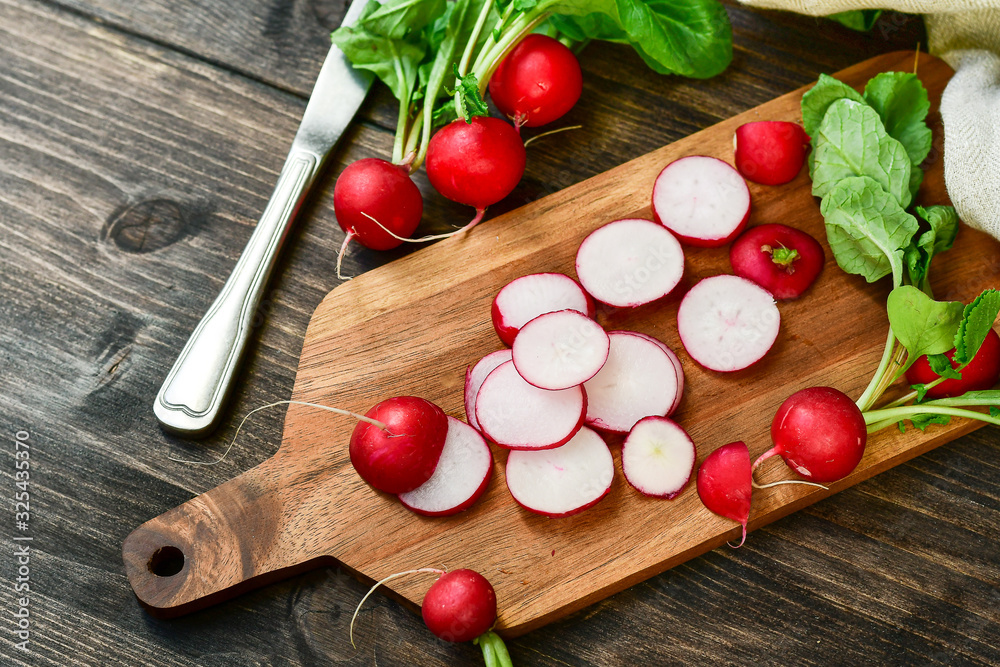 radish vitamin salad, sliced fresh radish on wooden Board. salad recipe with seasonal vegetables, healthy diet food. selective focus radish vitamin salad, sliced fresh radish on wooden Board. salad recipe with seasonal vegetables, healthy diet food. selective focus