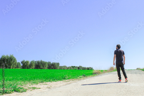 man walking on road © minervaed