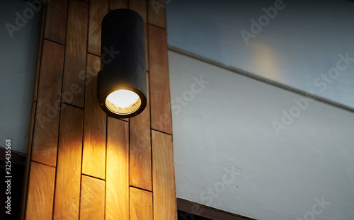 lamp on wooden tile decoration pole with turn on light in dark time photo