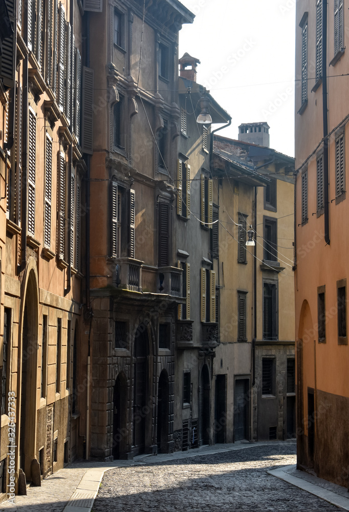A street scene of an elegant row of houses in the historic old town at Bergamo, Italy.