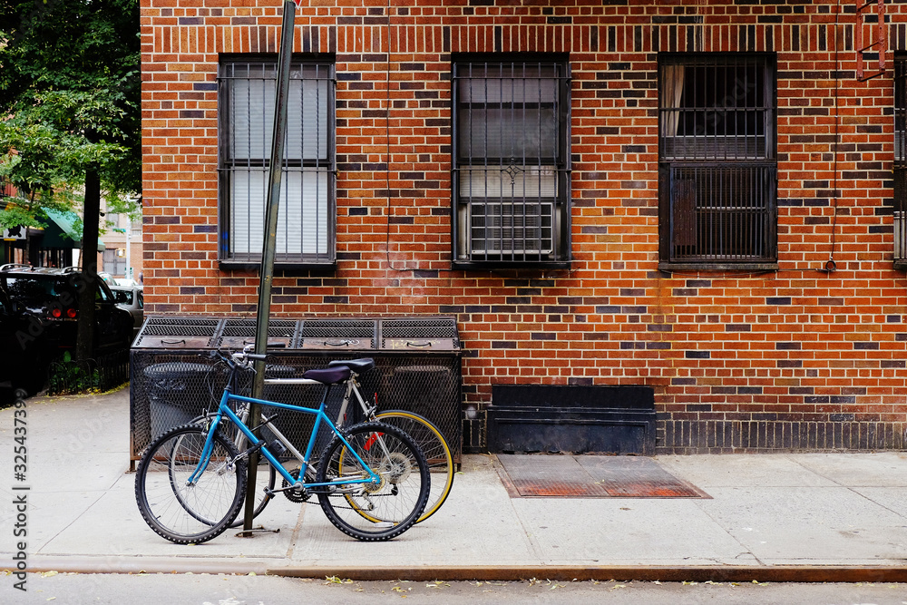 Beautiful building. Entrance door and bicycle, Manhattan New York. Classic apartment building in New York City.