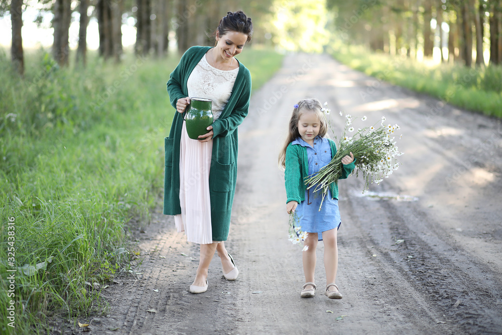 Mother with daughter walking on a road Mother with daughter walking on a road