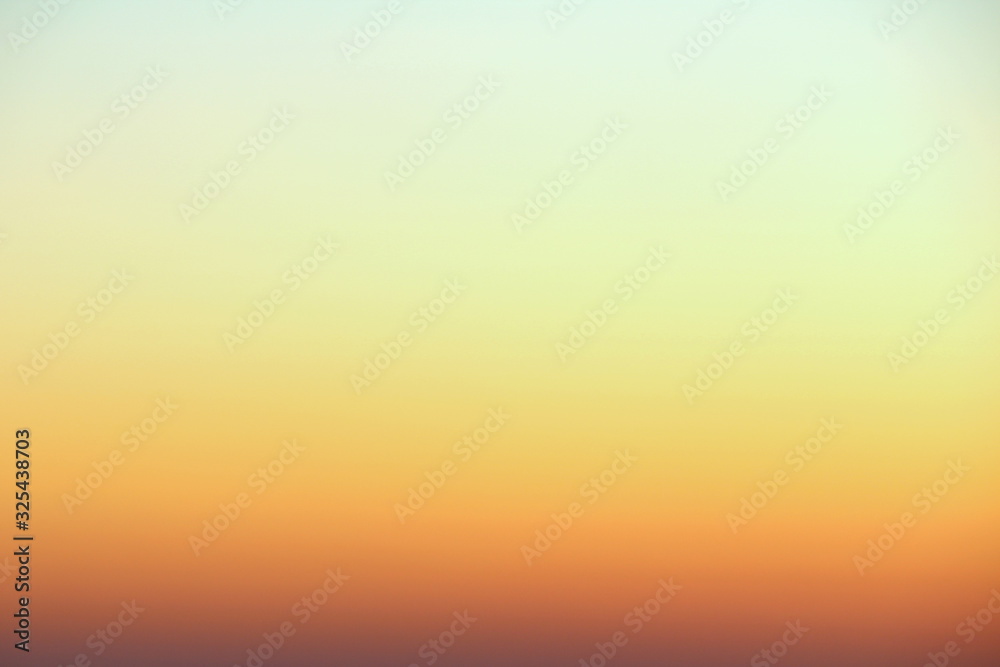 Flaming sky over the horizon during sunset or sunrise. Bright iridescent colors of yellow, orange and red. Colored background for text and design