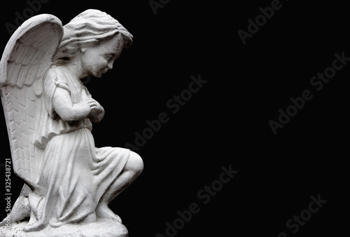 Little angel on black background. Annunciation and suffering