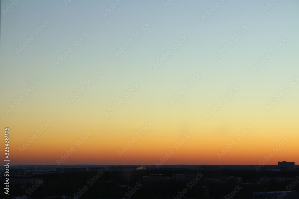 Flaming sky over the horizon during sunset or sunrise. Bright iridescent colors of yellow, orange and red. Colored background for text and design Flaming sky over the horizon during sunset or sunrise. Bright iridescent colors of yellow, orange and red. Colored background for text and design