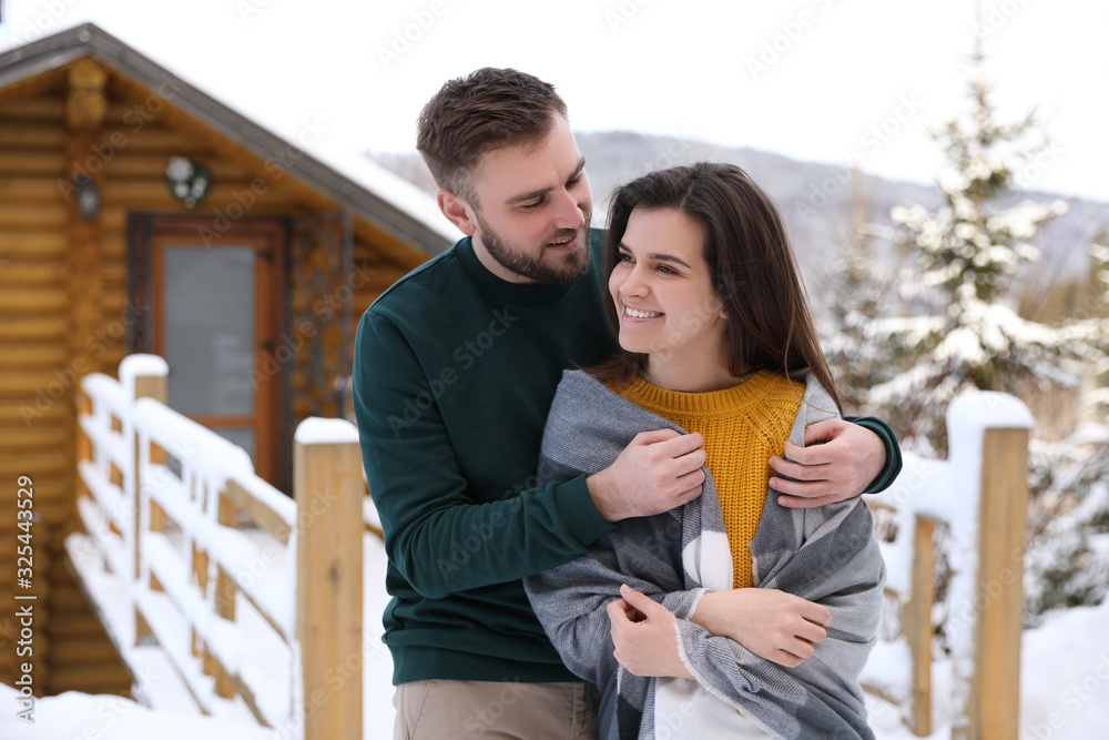 Fototapeta premium Lovely couple spending time together on snowy day. Winter vacation
