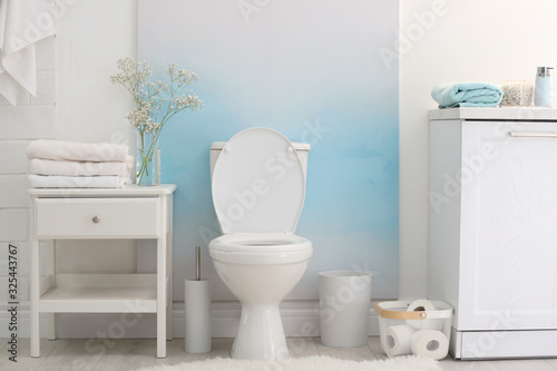 Modern toilet bowl in stylish bathroom interior photo