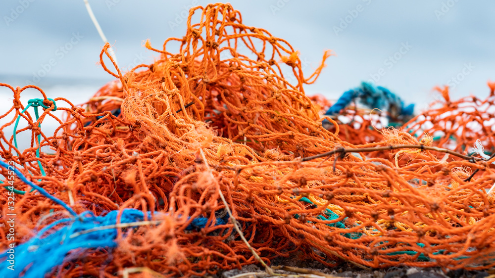 Fishing nets from industrial fishing on the beach as waste Fishing nets from industrial fishing on the beach as waste