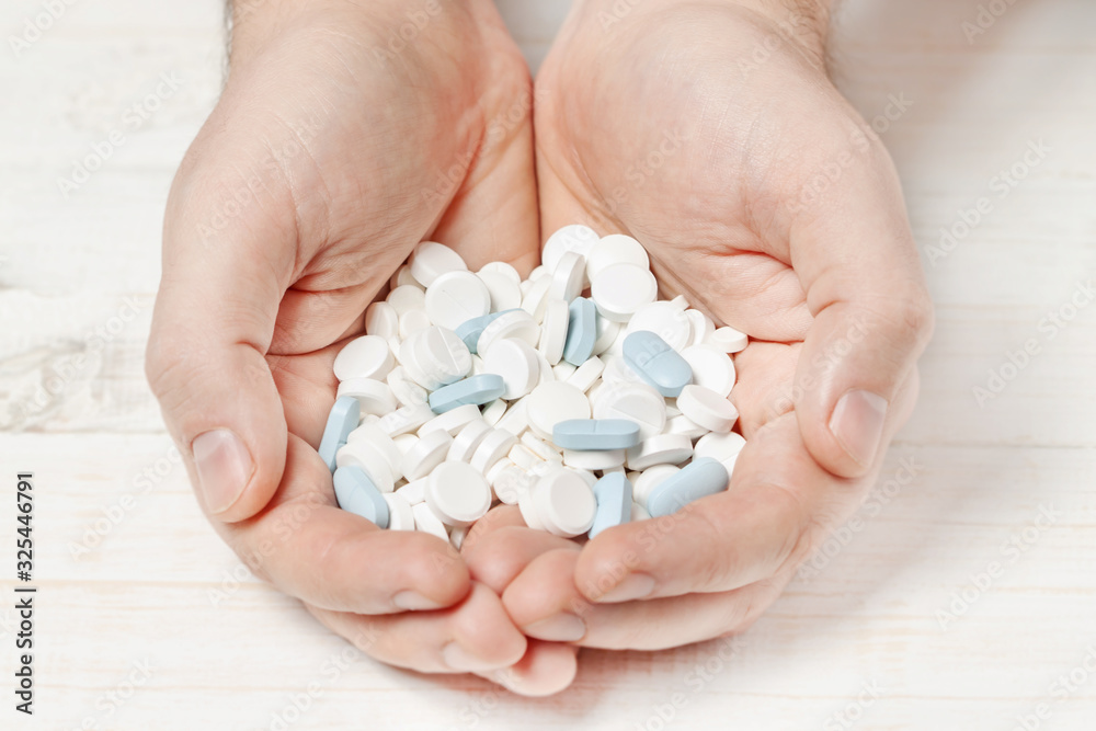 Bunch tablets pills in hands isolated macro Bunch tablets pills in hands isolated macro