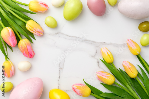 Flowers composition. Yellow and pink flowers on marble background. Spring  8 of march  woman day  mothers day  easter concept. Flat lay  top view  copy space.