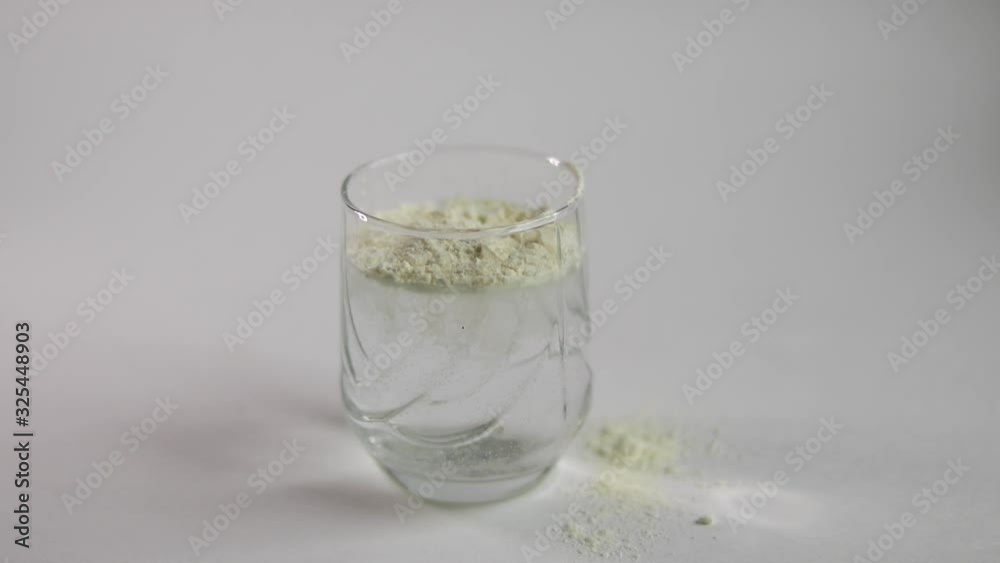 Collagen powder is placed in a glass with a measuring spoon. Freeze frame Additional protein intake. Natural supplements for beauty and health. Collagen based plant concept. Flatlay, top view. Collagen powder is placed in a glass with a measuring spoon. Freeze frame Additional protein intake. Natural supplements for beauty and health. Collagen based plant concept. Flatlay, top view.