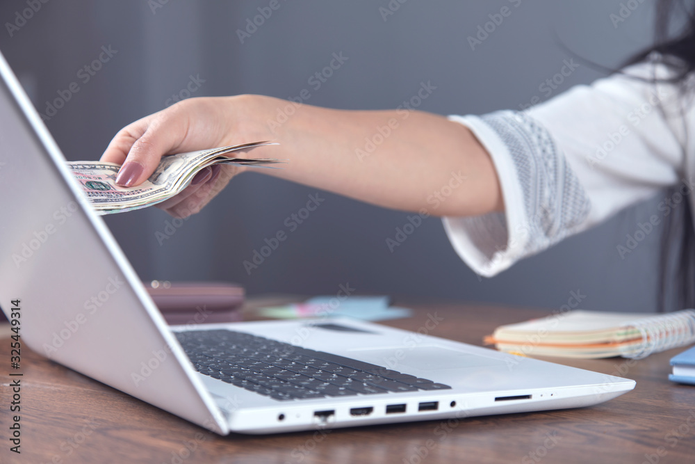 woman hand money with computer woman hand money with computer