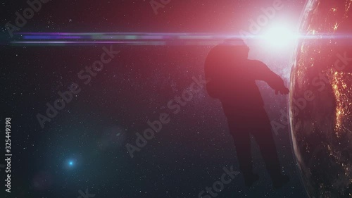 Astronaut man silhouette against realistic Earth. Back view of spaceman in deep space. Sun appear out of illuminate planet surface. 3d animation. Science concept. 4K. Elements media furnished by NASA