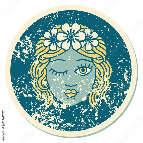 distressed sticker tattoo style icon of a maidens face winking
