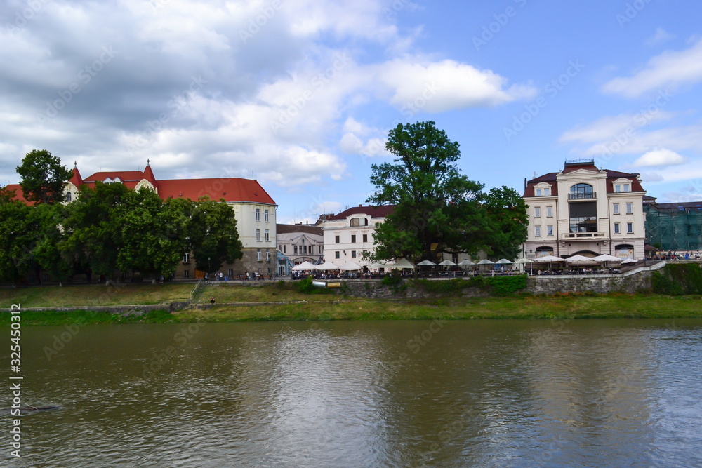 river and embankment, blue sky, white clouds, linden trees, Uzhhorod, Ukraine