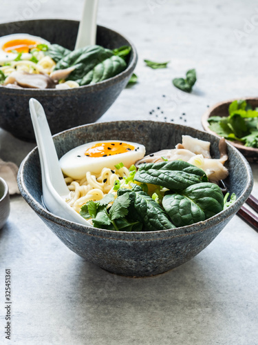 Vegetarian Miso Ramen with Mushrooms, raw Spinach and boiled Egg in blue bowl