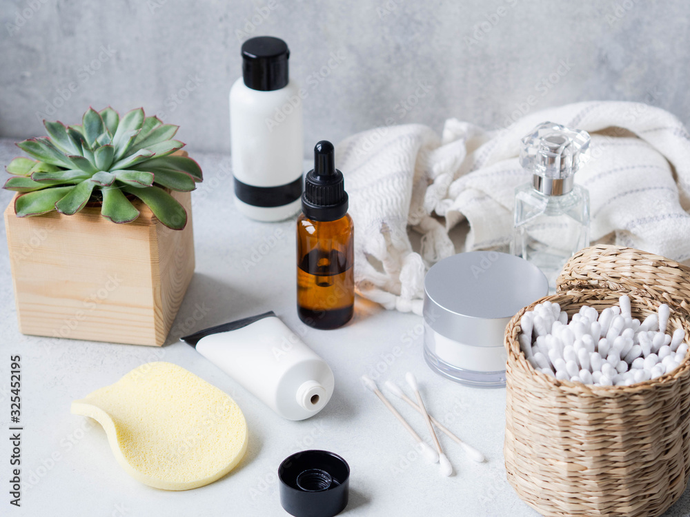 Set of female skin care products. Makeup products and skin cleansers on gray background. Copy space Set of female skin care products. Makeup products and skin cleansers on gray background. Copy space