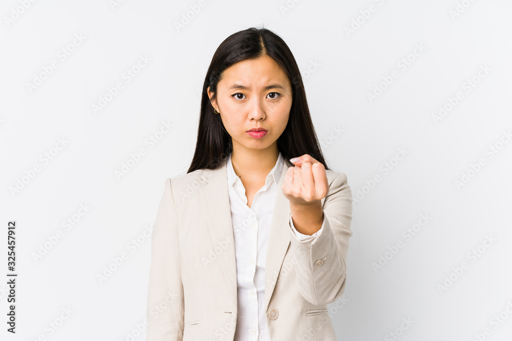 Young chinese business woman isolated showing fist to camera, aggressive facial expression. Young chinese business woman isolated showing fist to camera, aggressive facial expression.
