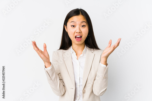 Young chinese business woman isolated receiving a pleasant surprise, excited and raising hands.