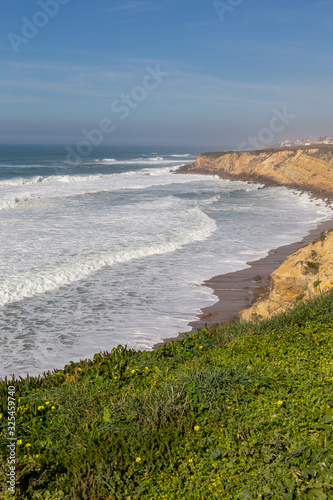 Ocean coast with grass  moviment waves with foam. Wind power. Turquoise water.