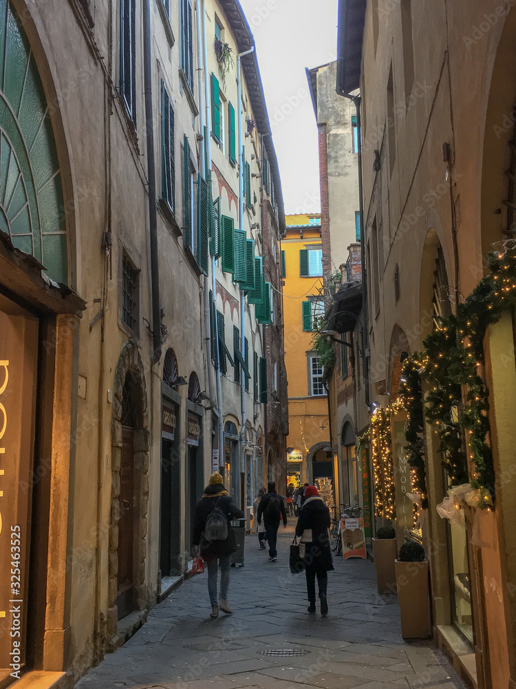 people walking on an Italian  street city during Christmas  time